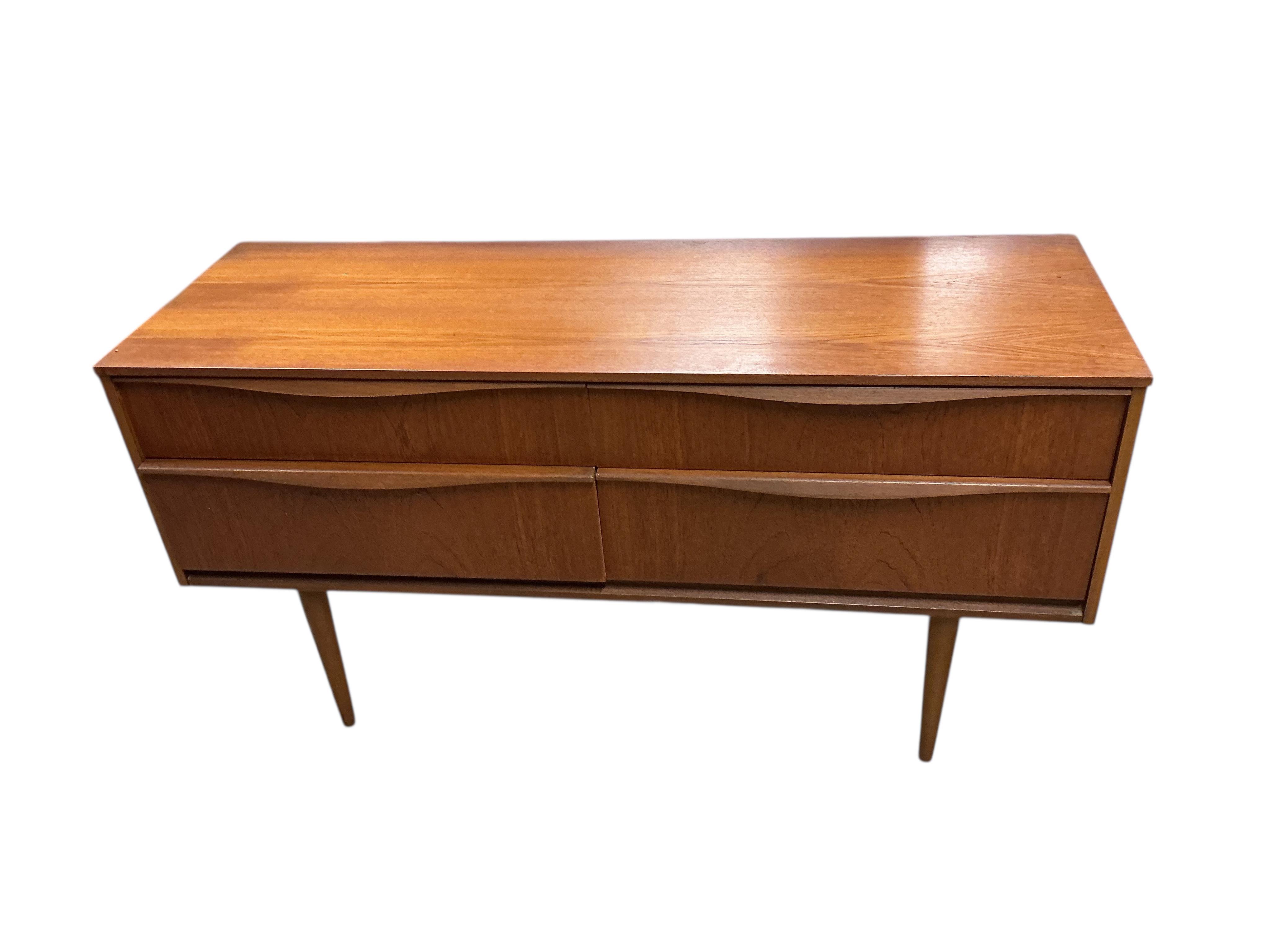 A mid century teak four drawer chest, width 124cm, depth 42cm, height 66cm